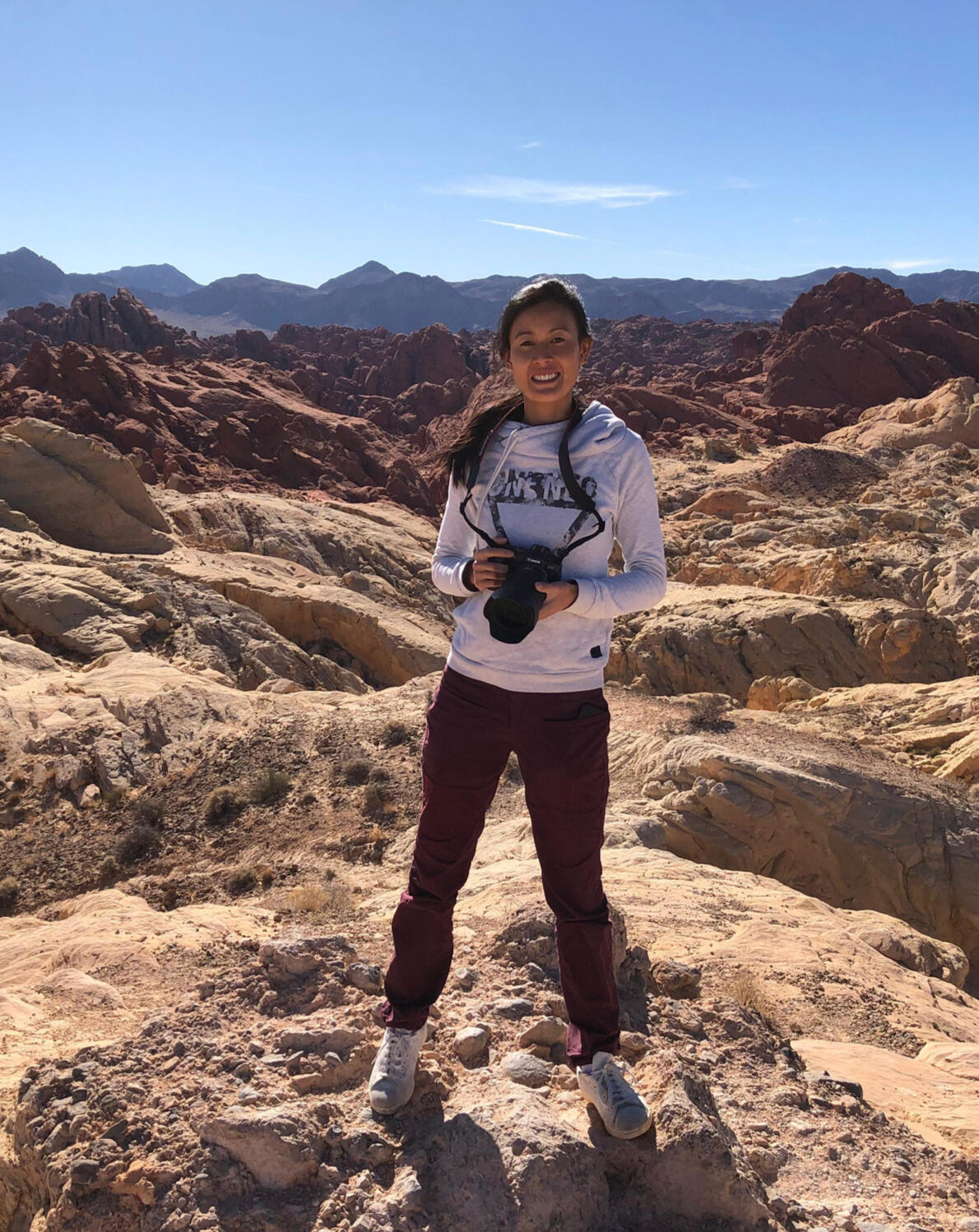 It is An Photographer standing with her camera in hand